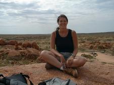 Caro on top of some marbles - in the backgroung: the Australian Outback