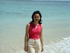 Kristel in front of the blue water protected by the corail barrier